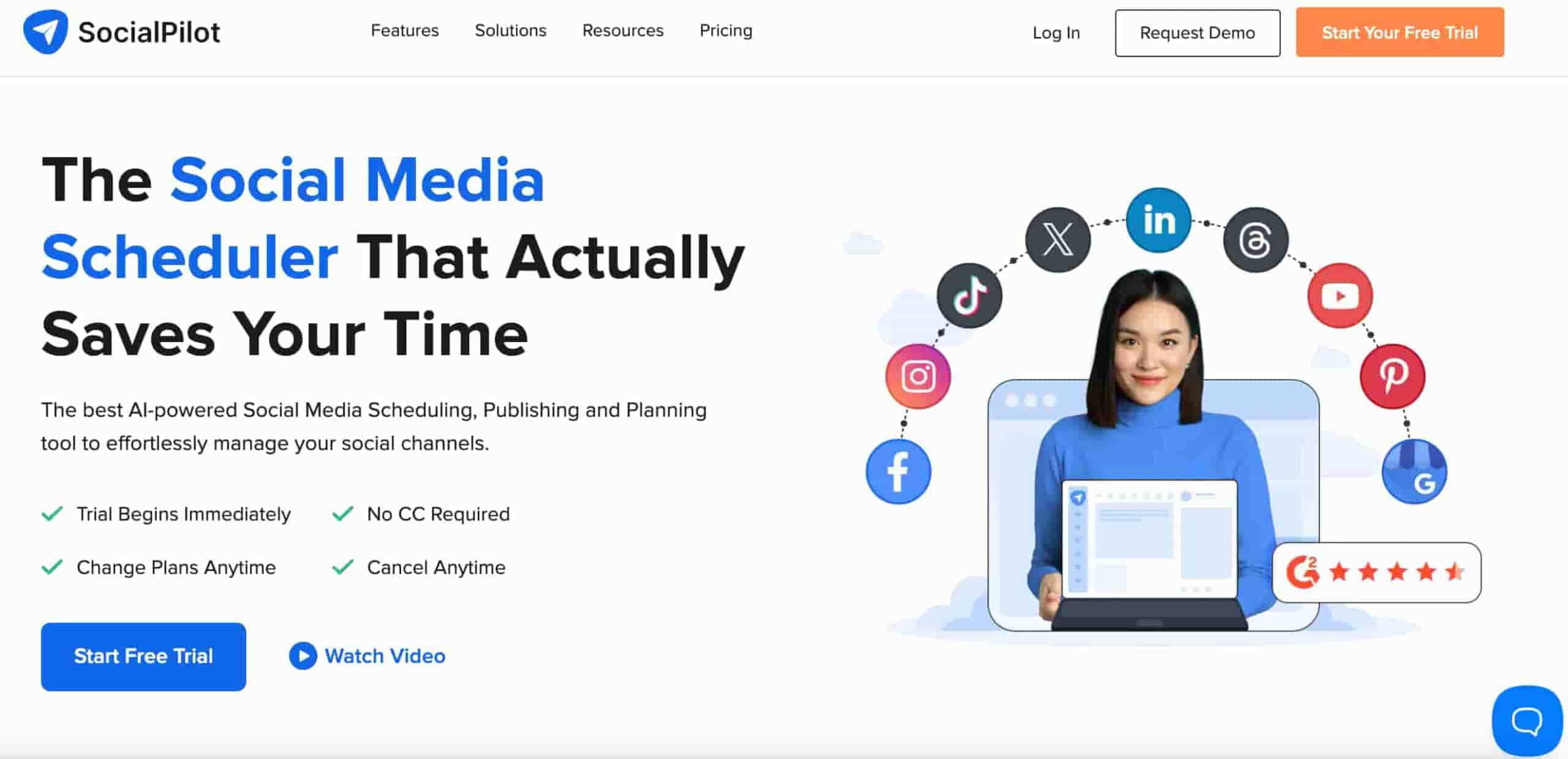 SocialPilot homepage showing a woman smiling with several social media icons hovering above her head and text on the side that reads "the social media scheduler that always saves you time"