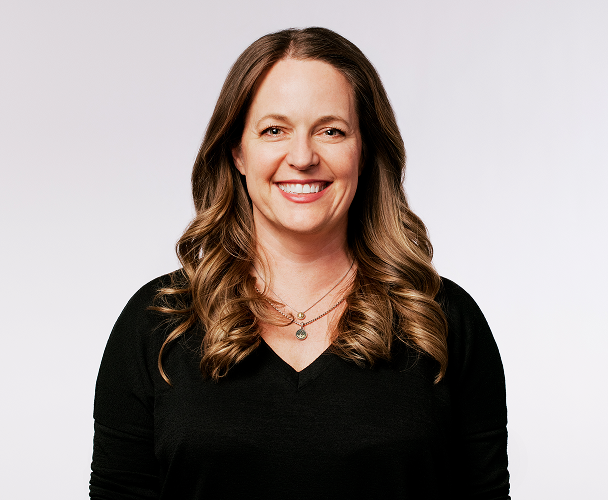 Headshot of Colleen Geiselhart, SVP, Customer Experience, wearing a black top.
