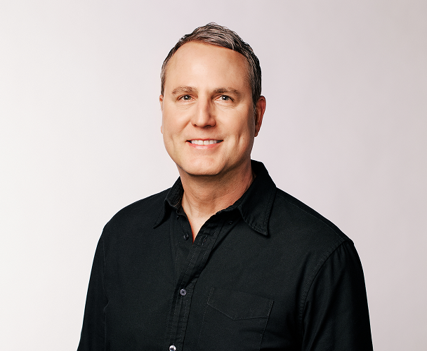 Headshot of Scott Morris, Chief Marketing Officer, wearing a black collared shirt.